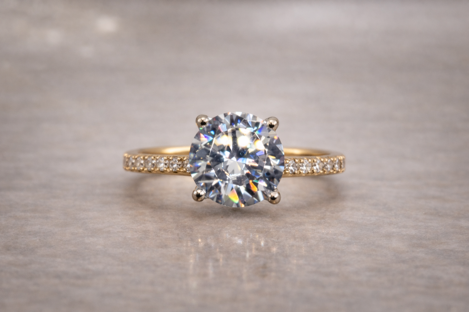 round diamond set in yellow gold with bezeled side diamonds