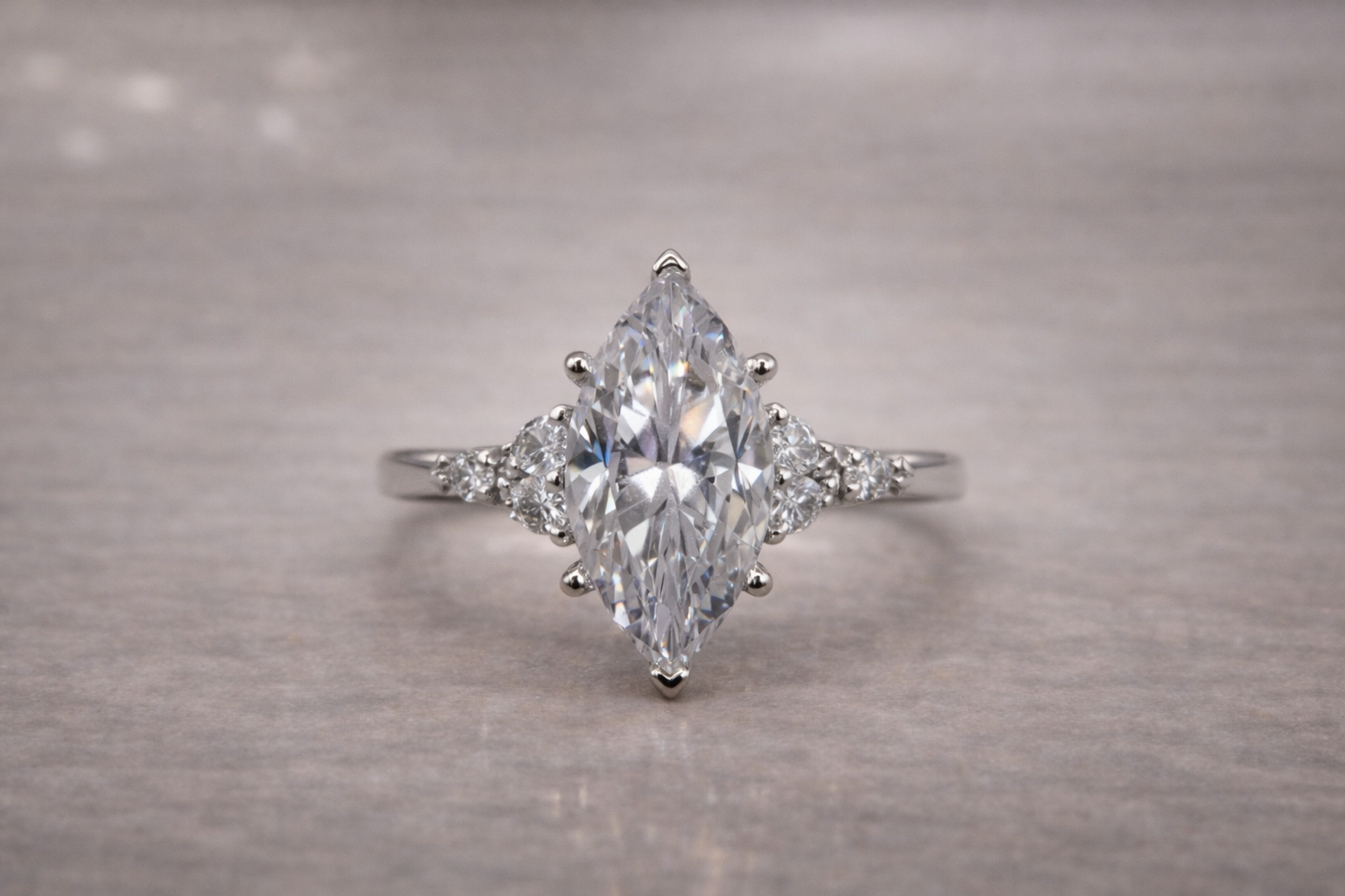 marquise diamond set in white gold with floral side stones