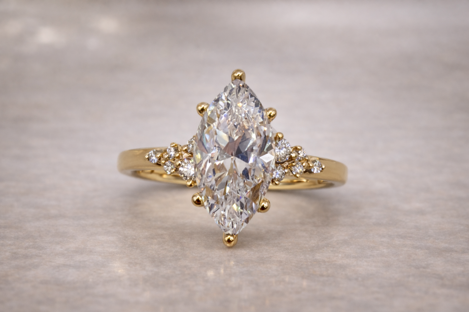 Marquise diamond engagement ring with side stones set in yellow gold