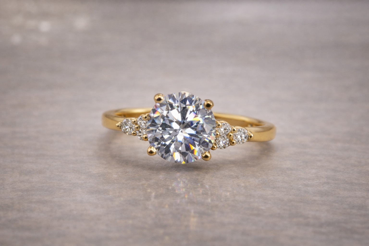 round diamond engagement ring with cluster side stones set in yellow gold